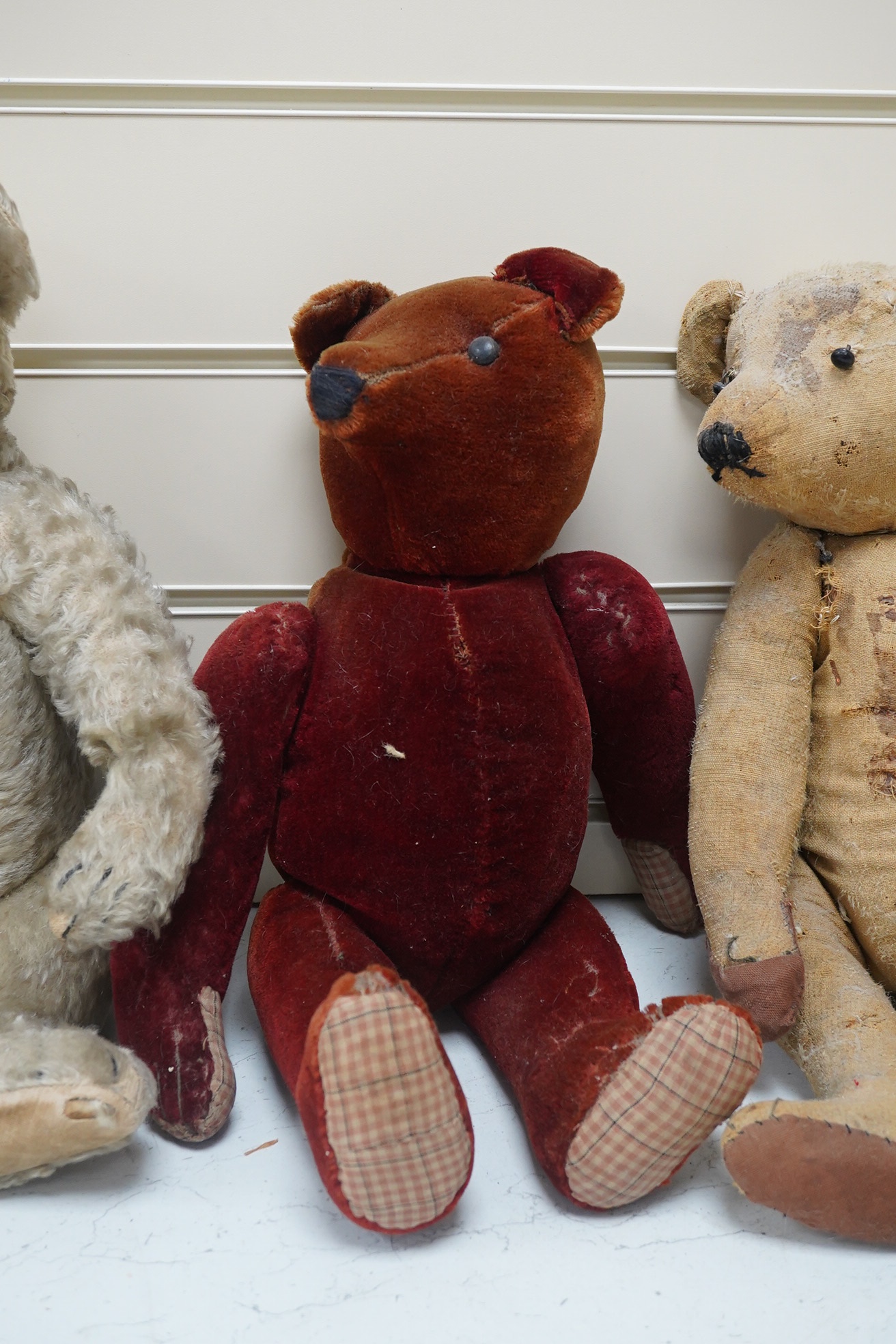 Three bears, one Chiltern 1950's. Condition - good, missing eyes, height 46cm, 1930's plush ear, button eyes. Condition - faded, height 42cm, 1930's bear, height 40cm. Condition - poor.